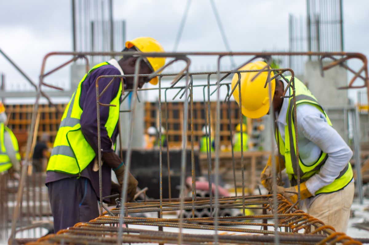 Construction workers in hard hats and safety vests working together on site