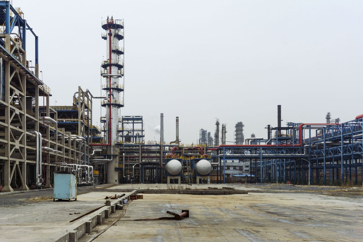 Oil and gas refinery with process pipelines and industrial towers